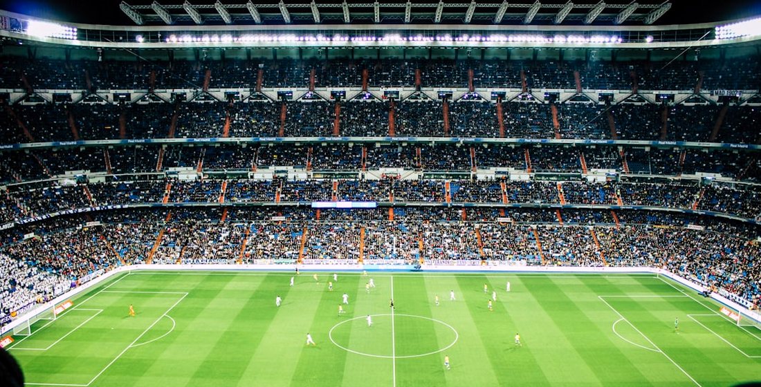 A packed football stadium under floodlights, streamed live in 4K on IPTVMeezzy